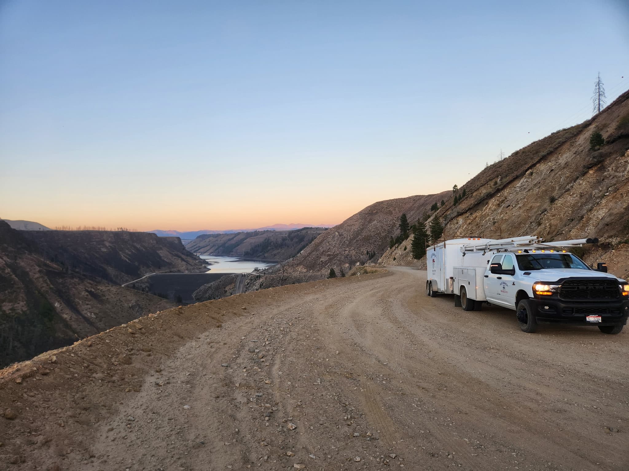 Company service truck positioned on a canyon access road in Idaho.