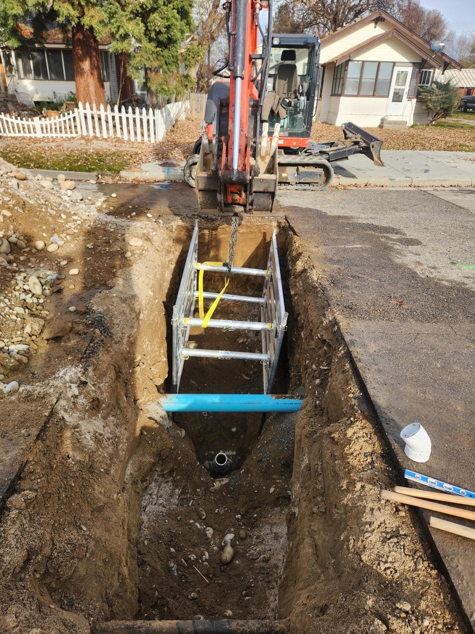 Open trench access for underground drain or sewer repair work.